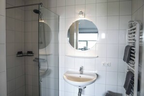 Shower, hair dryer, towels, toilet paper