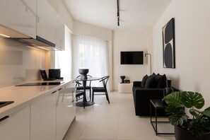 Enjoy a sophisticated atmosphere in this stylish apartment with a functional kitchen, dining area, and comfortable living space.