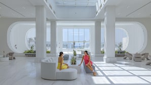 A spacious, modern lobby with a high ceiling, large windows, and a central seating area. - White Hills Resort - Posh Club (Sharm El Sheikh)