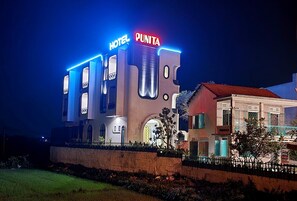 A hotel with a modern facade, illuminated signage, and a well-maintained exterior. - Punita Hotel (Da Nang)