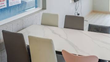 A conference room with a marble table and six chairs.