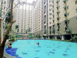 Una piscina rodeada de edificios residenciales altos.