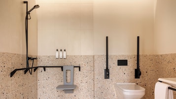 A modern bathroom with a shower, toilet, and towel rack.