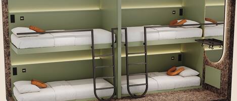 A bunk bed room with two beds, each with a pillow and a headboard. There are two ladders for access to the upper bunk.