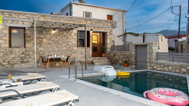 A stone building with a pool, outdoor seating, and a pergola. - La Si'Ma, with private pool, 2-bedrooms close to Margarites Village (Plevriana)