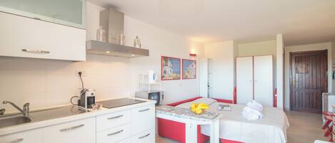 Fridge, microwave, stovetop, coffee/tea maker