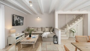 A living room with a sofa, coffee table, and a staircase.