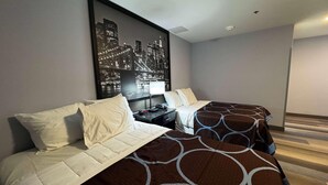 A hotel room with two beds, a nightstand, a cityscape artwork on the wall, and a wooden floor. - Super 8 By Wyndham Brooklyn Fulton Street (Brooklyn)
