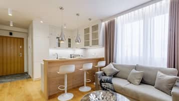 Comfort Apartment | Living area | 52-inch flat-screen TV with satellite channels