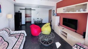 A modern living room with a TV, sofa, and bean bags. - Costa del Sol apartment. (Fuengirola)