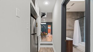 A modern kitchen with a built-in oven and a stainless steel refrigerator.