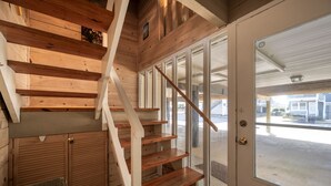 A wooden staircase with a glass door leading outside. - Oceanblock Townhome Mid Town with Pool (Ocean City)