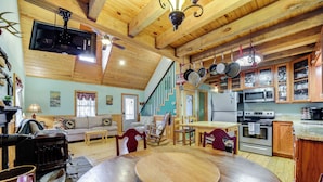 A cozy kitchen with wooden cabinets, a dining table, and a built-in oven. - Santeetlah Lake Retreat w/ Dock: Walk to Water! (Robbinsville)