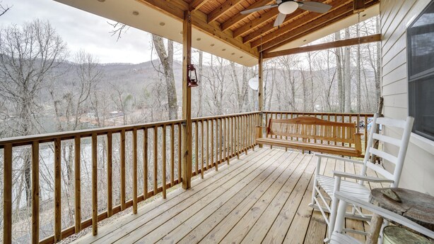 A wooden deck with a ceiling fan, wooden railings, and a bench. - Santeetlah Lake Retreat w/ Dock: Walk to Water! (Robbinsville)