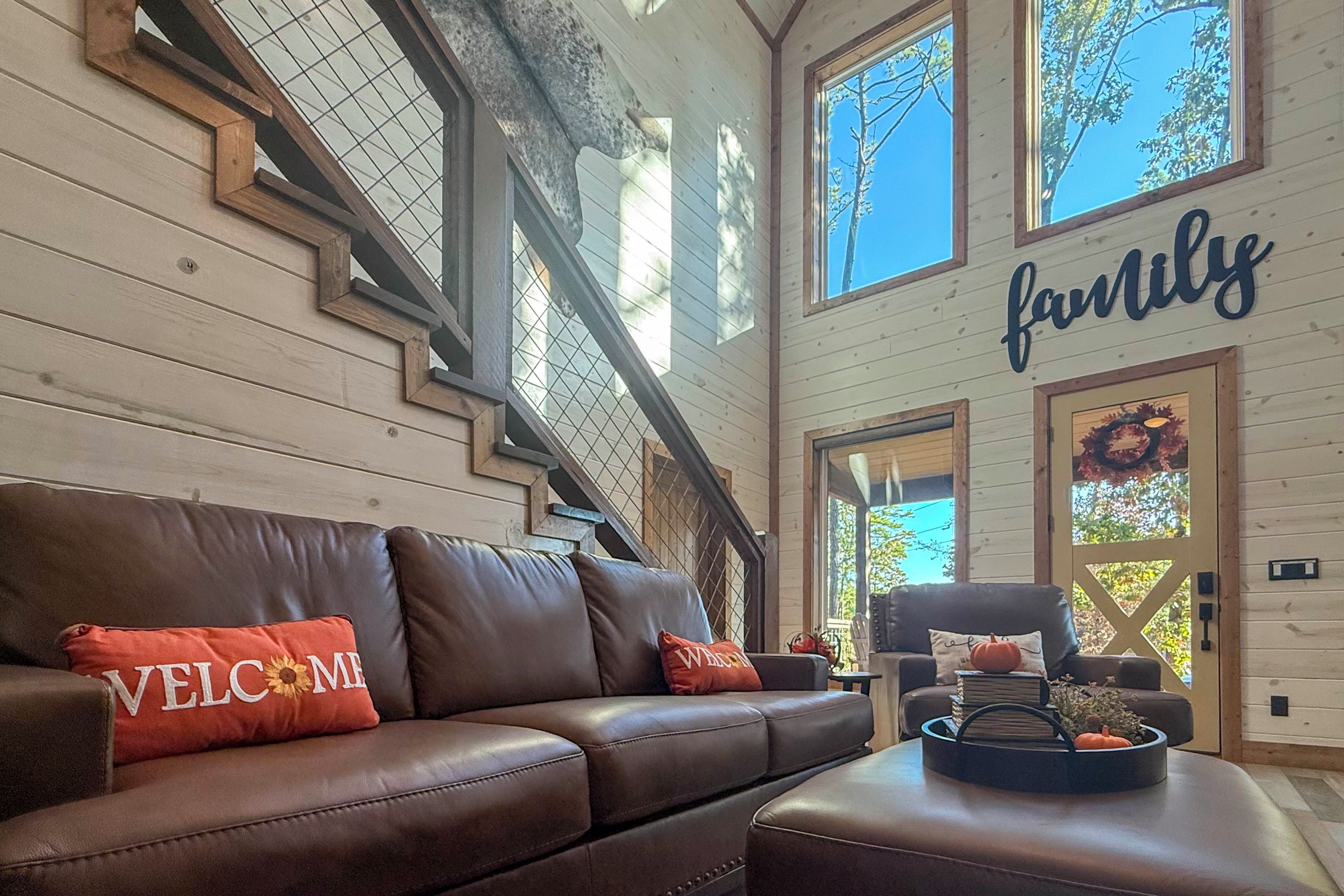 A wooden interior with a leather sofa, a staircase, and a 'family' sign.