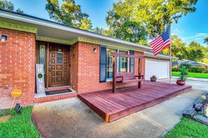 A brick house with a front porch, a flag, and a mailbox. - Home 2.5 Mi to Fort Stewart w/ Heated Pool (Hinesville)