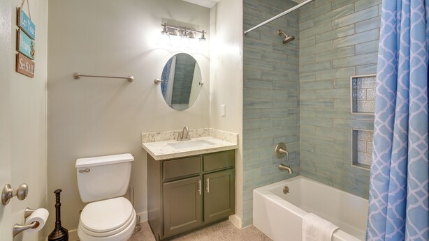A bathroom with a toilet, sink, and bathtub. - Galveston Vacation Home: 2 Mi to Galveston Beach! (Galveston)