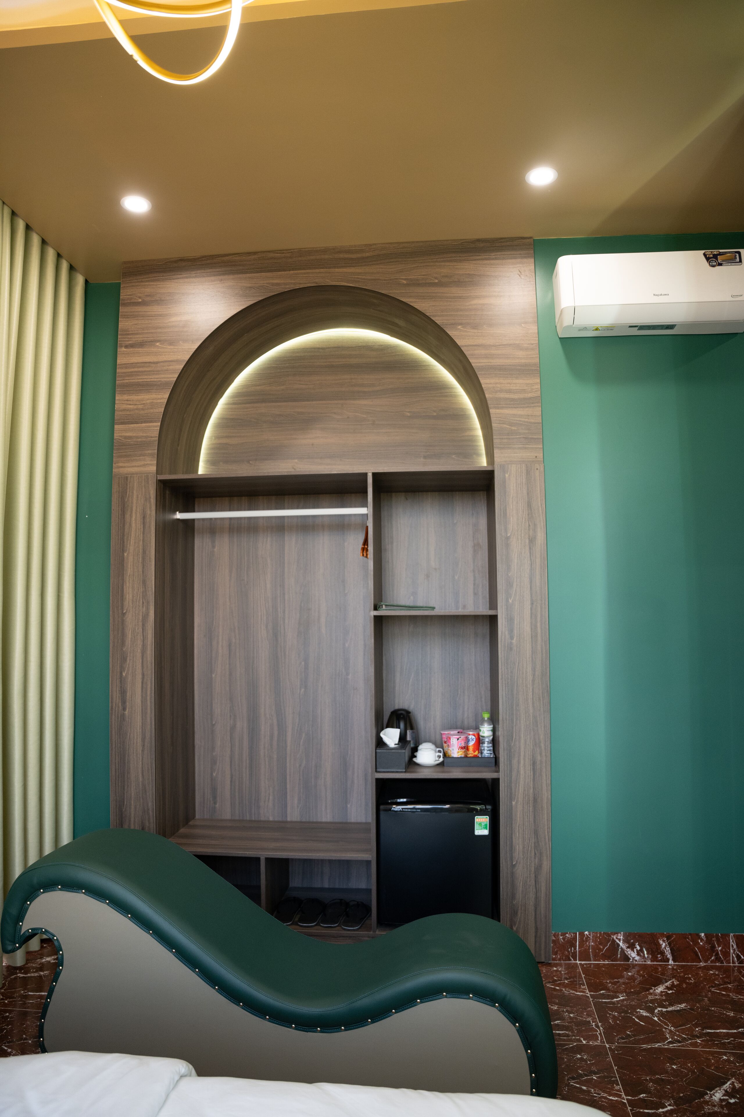 A bathroom with a shower area, a built-in vanity with shelves, a hairdryer, and a towel rack.