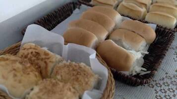 Freshly baked treats are arranged on a woven basket in a cozy dining area.