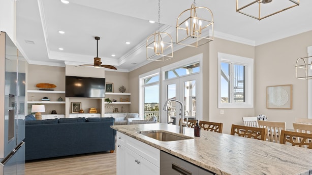 A modern kitchen with a large island, built-in appliances, and pendant lighting. - Oyster Perpetual, 5 bedroom 5 bathroom home that ensures your stay is timeless. (Ocean Isle Beach)