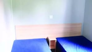 A room with two single beds, a wooden headboard, and a light-colored wall. - ZEcamping 3* piscine locatif BBQ 31m2 4 pers (Dévillac)