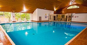 An indoor swimming pool with clear water, surrounded by white walls and wooden ceiling beams. - V+B's Hygge, Gorgeous Lake View at V&B Hygge (Troutbeck Bridge)