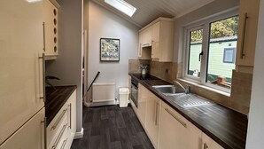 A compact kitchen with a window, a radiator, and a skylight. - V+B's Hygge, Gorgeous Lake View at V&B Hygge (Troutbeck Bridge)