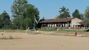 A building with outdoor seating and a flagpole.