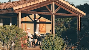 A rustic wooden building with a covered patio area.