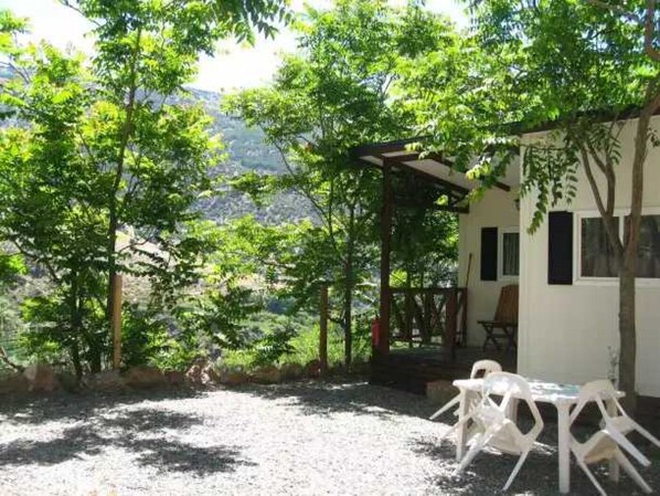Relax in a serene outdoor space with a patio, pergola, and scenic mountain views.