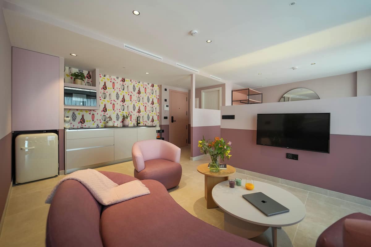 A modern living room with a sofa, armchair, and a small coffee table.