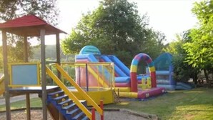 A playground with a slide, a climbing structure, and a small pavilion.
