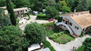 Residential area with various buildings surrounded by lush greenery and trees.