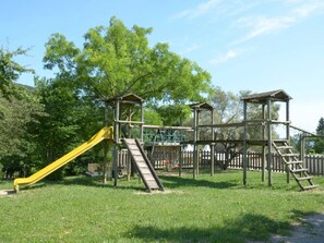 A playground with a slide and climbing structures.