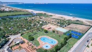 An aerial view of a coastal property with a swimming pool, tennis courts, and a beach. - ZEcamping 4 étoiles piscine dog friendly club enfant mobil-home TV LV clim (Pals)