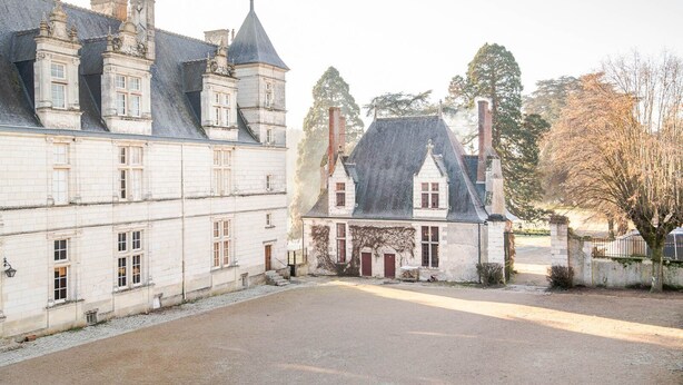 A courtyard with a large building featuring multiple chimneys and a stone facade. - 16th century hunting lodge - Château de Nitray (Athée-sur-Cher)