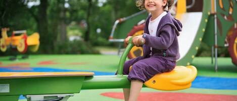 A child playing on a playground equipment.