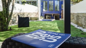 A book titled 'beyond the city' on a woven surface outdoors. - GuestReady - Alegria 293 - Room 2 (Porto)