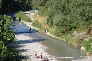 Guests can enjoy a serene riverside setting surrounded by lush greenery and a calm river.