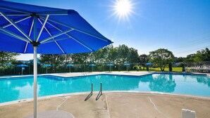 A clear blue swimming pool with a sun shining overhead, surrounded by a fence and trees. - Townhome with community pool, tennis court, and only 2 miles from Bethany Beach! (Frankford)