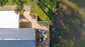 A two-story building with a flat roof and a deck area.