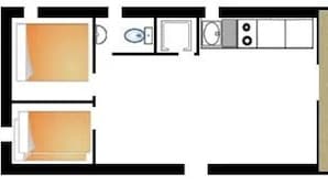 A kitchen with a refrigerator, stove, sink, and cabinets.