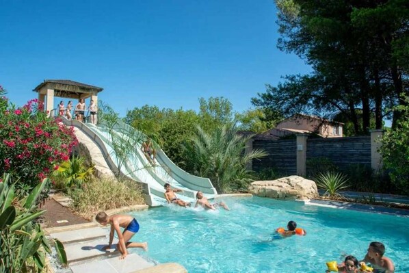 Relax by the pool surrounded by lush greenery and enjoy a refreshing swim or a thrilling water slide experience.