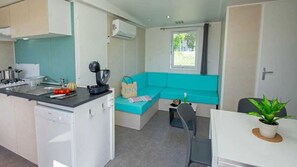 Enjoy a functional living space with a kitchenette, dishwasher, and cozy seating area.