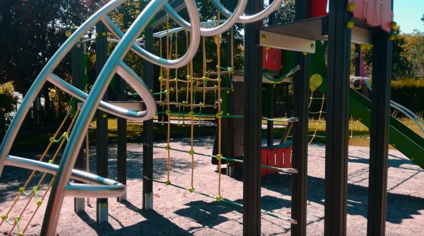 A playground with a climbing structure and a slide.