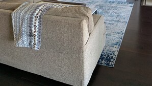A living room with a beige sofa, a fireplace, a television, and a ceiling fan. - Lake House (Lake Placid)