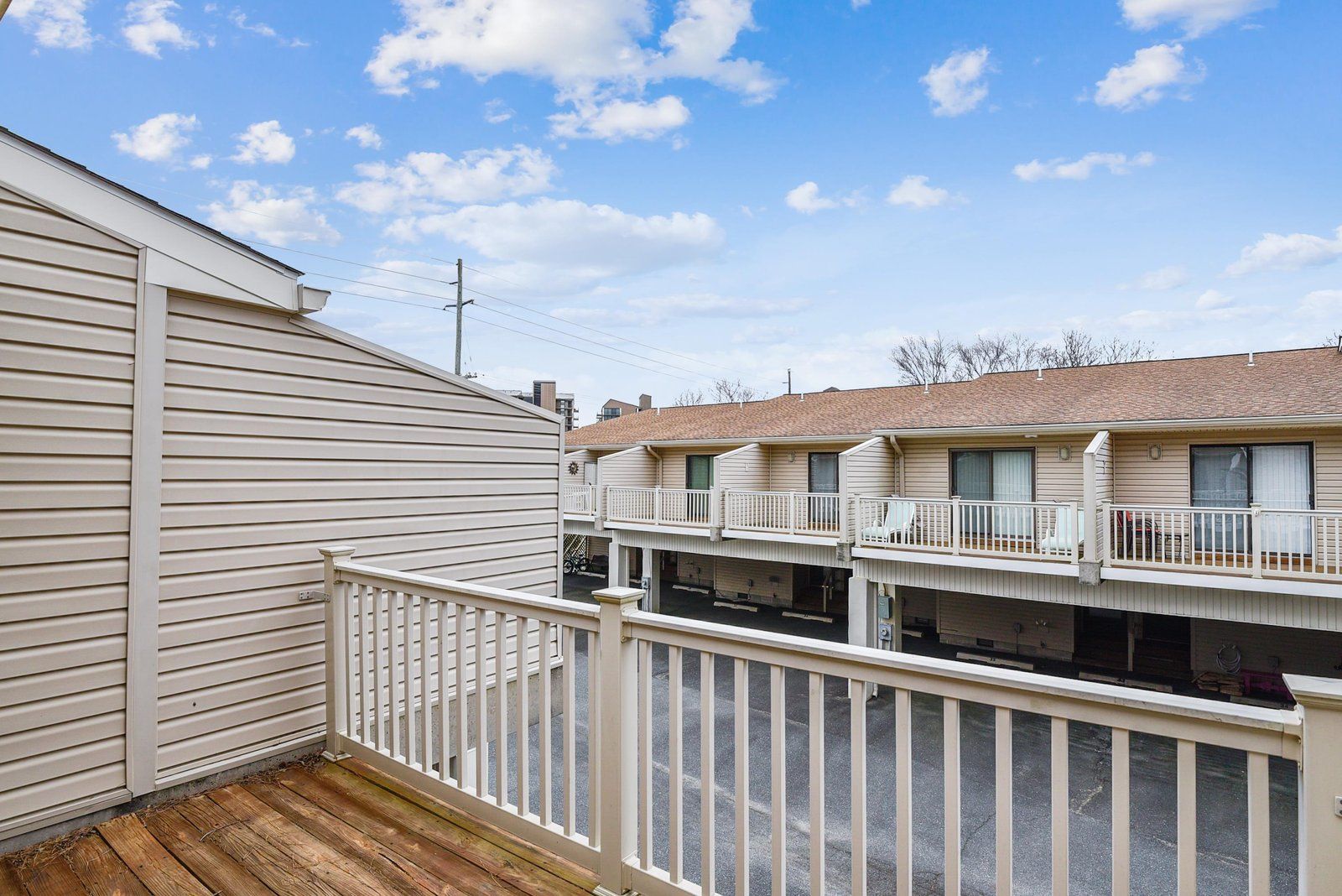 A residential building with a wooden deck and balconies.
