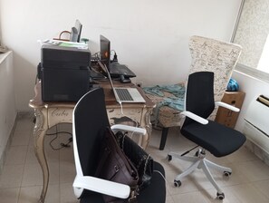 A workspace with a desktop computer, a laptop, two office chairs, and a desk cluttered with papers and a printer. - MacDonald Apartments A5  (Lagos)
