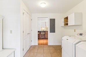 A bright, dedicated laundry space makes keeping your vacation wardrobe fresh effortless, with full-sized machines and convenient cabinet storage for all your essentials.