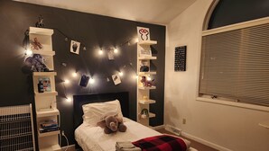 A bedroom with a bed, shelves, and a window. - Large Home close to everything, Dogs welcome. (Fitchburg)
